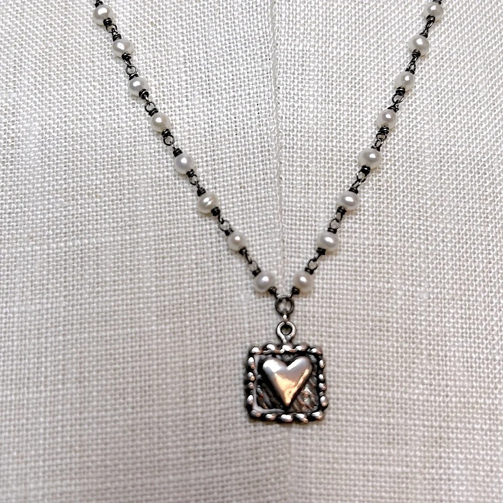 Silvertone heart charm dainty necklace with delicate white pearls on the chain